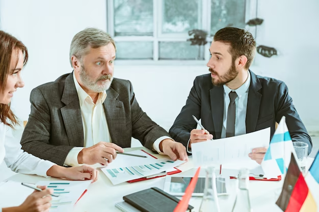 people working together at table.