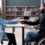 Woman shaking hands with a disabled man